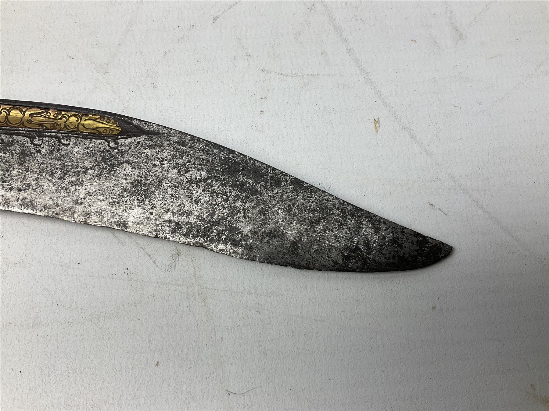 19th century Singhalese knife pia kaetta, the 20cm steel blade inset with yellow and white metal, with metal mounted carved pistol grip, in plain wooden scabbard L33cm overall