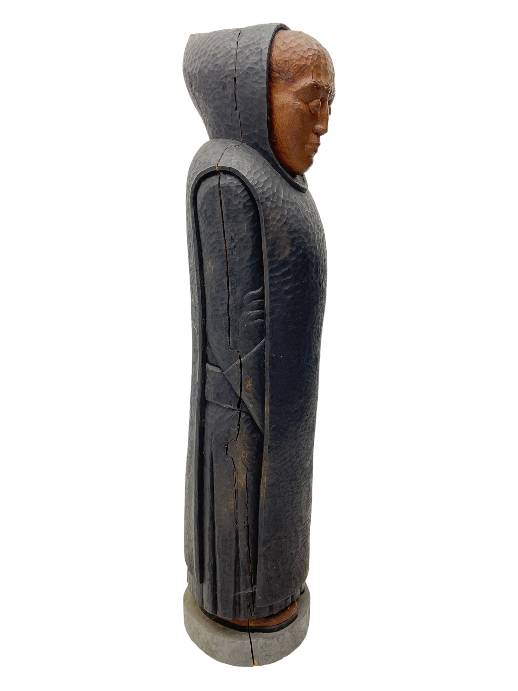 John Bunting FRBS, FRCA (1927-2002): Carved sculpture of a standing Monk in ebonised robes