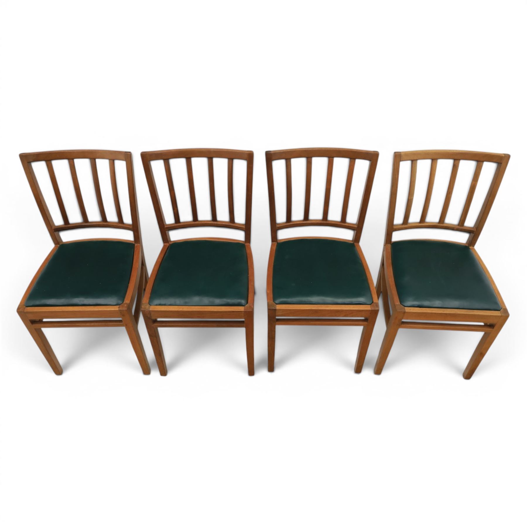 Mid 20th century teak extending dining table, together with eight teak chairs with green leather seats, extends to 154cm