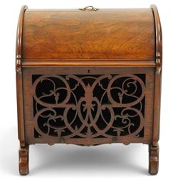 Victorian rosewood enclosed music Canterbury, the domed hinged cover enclosing a three-division interior, above a pierced scrolling foliate fretwork front panel, flanked by curved uprights and raised on scroll feet, hinged top applied with brass registration lozenge for 19 January 1860