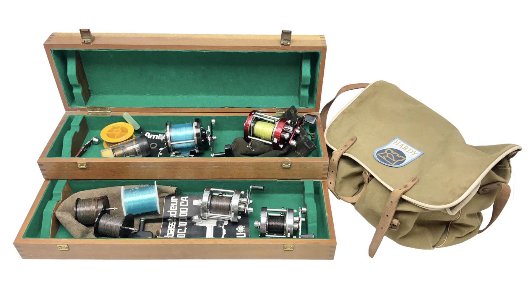 Four Abu fishing reels, comprising Ambassadeur 9000, Ambassadeur 7000, Ambassadeur 5500 and Ambassadeur 6500, together with additional line, hardy fishing bag and two wooden boxes