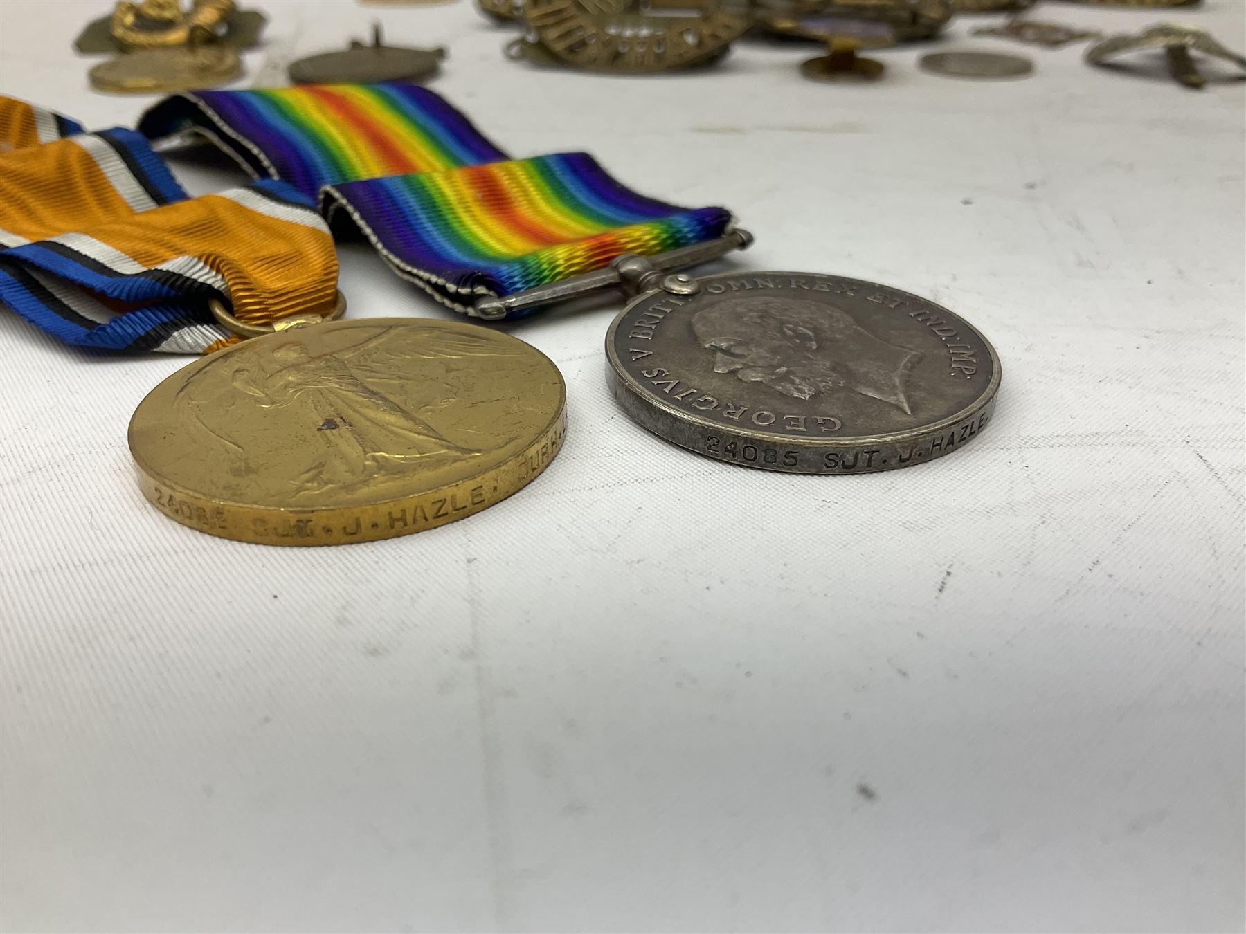 WW1 pair of medals comprising British War Medal and Victory Medal awarded to 24085 Sjt. J. Hazle Durh. L.I.; together with Durham Light Infantry cap and collar badges, shoulder titles, buttons etc; various royalty commemorative medallions etc