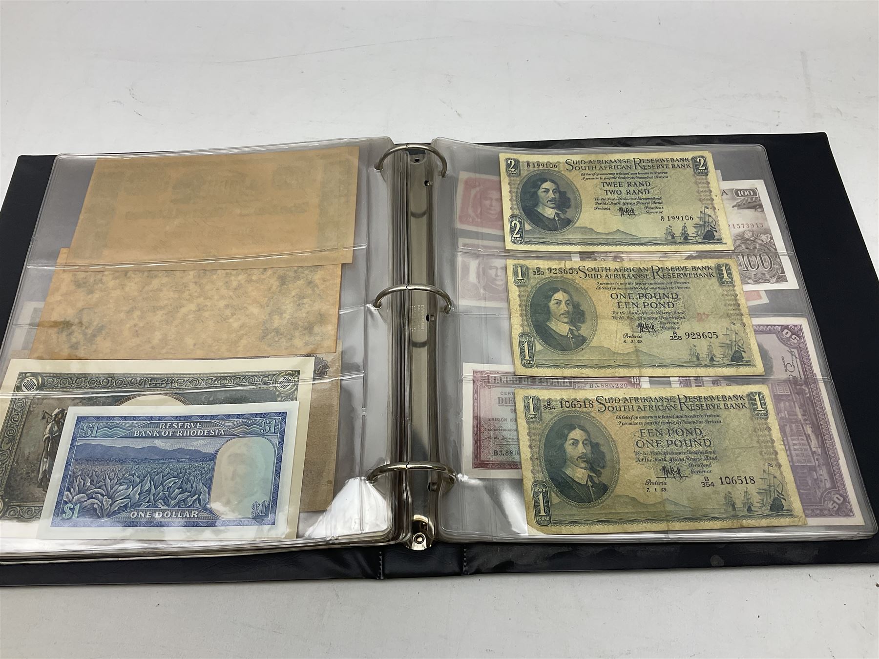 World banknotes, including Queen Elizabeth II The States of Jersey one pound 'DB202703', five pounds 'BB527762' and ten pounds 'AB651481', reserve bank of New Zealand two dollars '1L3 741894', King George V Straits Settlements one dollar 1st January 1935 'F/83 28924', various Bank of England notes etc, housed in two ring binder albums