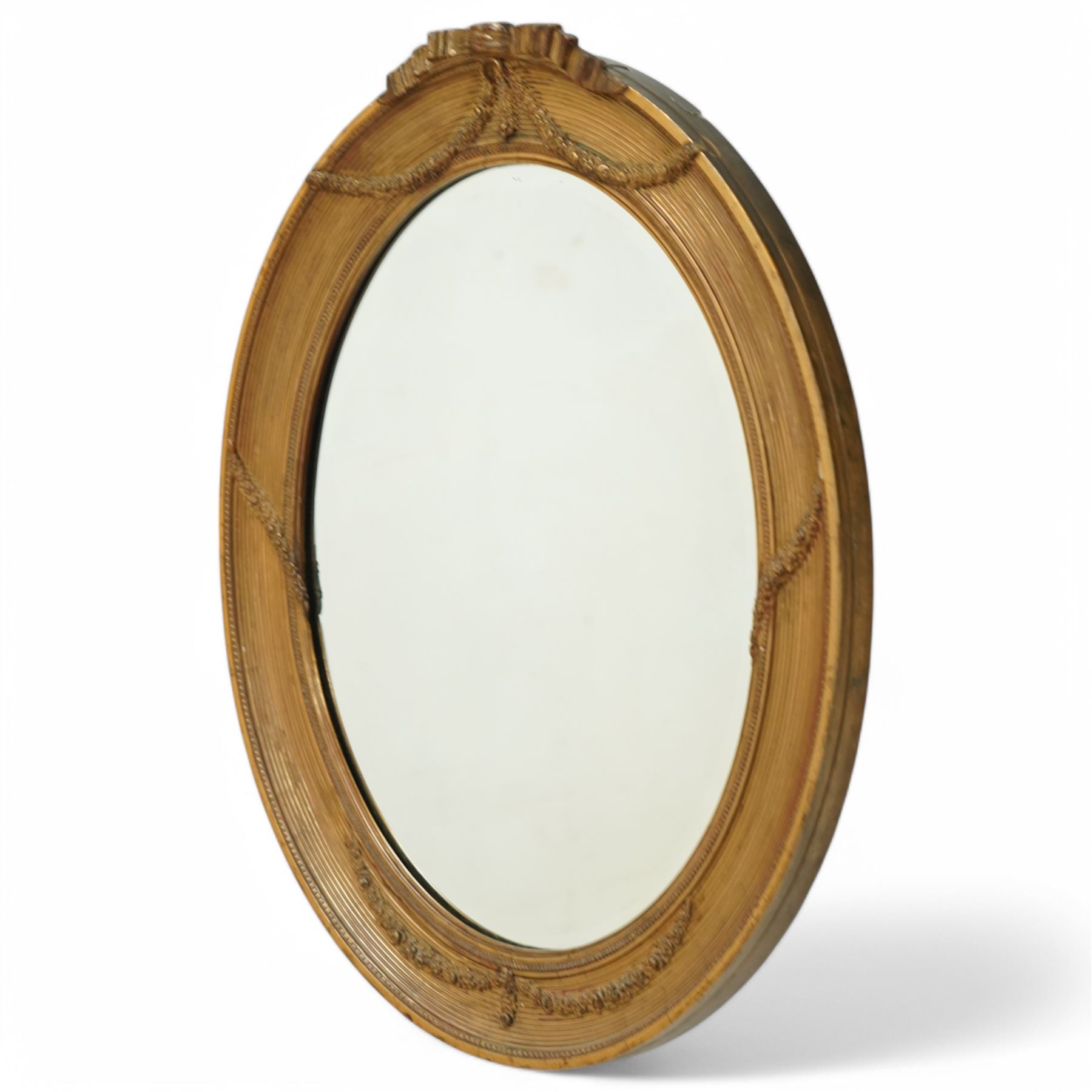 Edwardian neoclassical style oval giltwood mirror, ribbed frame, decorated with floral wreaths and ribbons 68x57cm