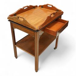 20th century mahogany butler’s tray on stand, with folding gallery tray top featuring shaped hand grips and brass hinges, fitted with single drawer and lower shelf, on square section legs with pierced brackets and castors