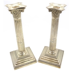 Pair of silver corinthian column candlesticks by Hawksworth, Eyre & Co Ltd Sheffield 1902, detachable sconces, weighted bases 23cm