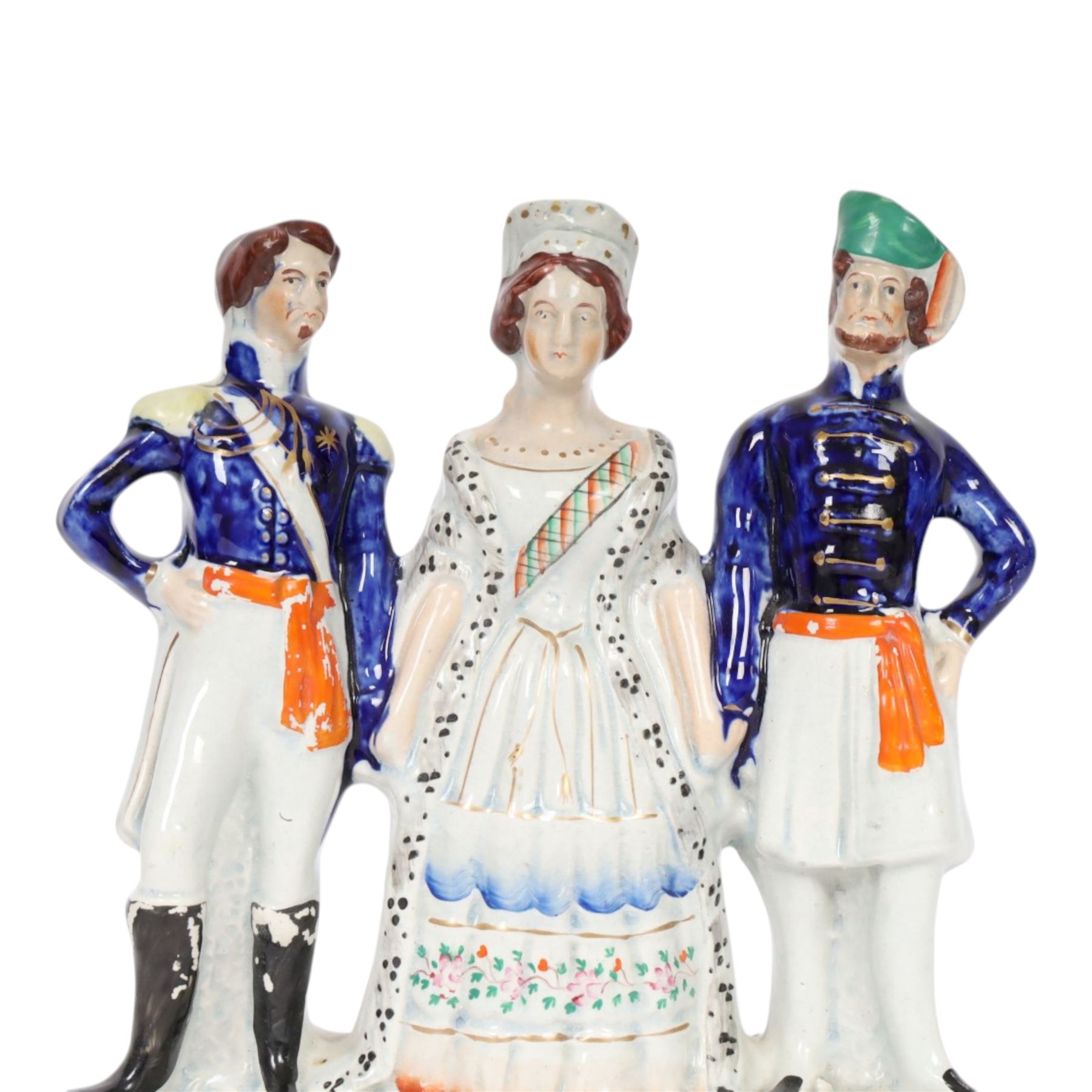Rare mid 19th century Staffordshire figure group, Napoleon III, Victoria and Abdul-Medjid, made to commemorate the alliance of the three nations in the Crimean War, Victoria stands central with Napoleon in military uniform to her right, and the Sultan to her left, upon a titled base, H23.5cm