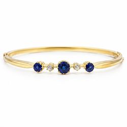 Early 20th century 18ct gold sapphire and diamond hinged bangle, the front set with three ...