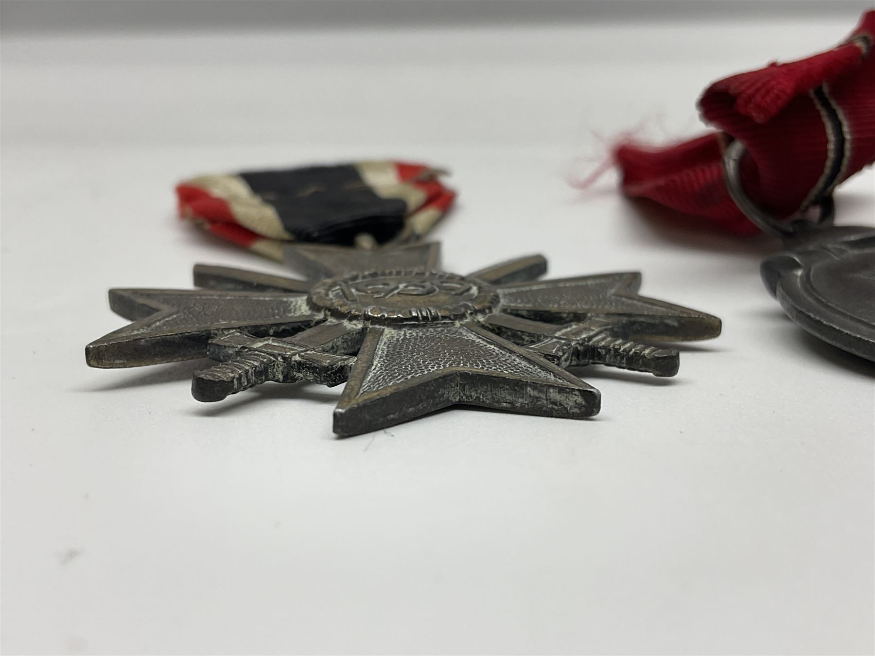 WW2 German Eastern Front Medal awarded to those who served on the German Eastern/Russian Front during the Winter Campaign period of 15th November 1941 to 15th April 1942 with original ribbon; German War Merit Cross with swords; and NSDAP Long Service Award (3)