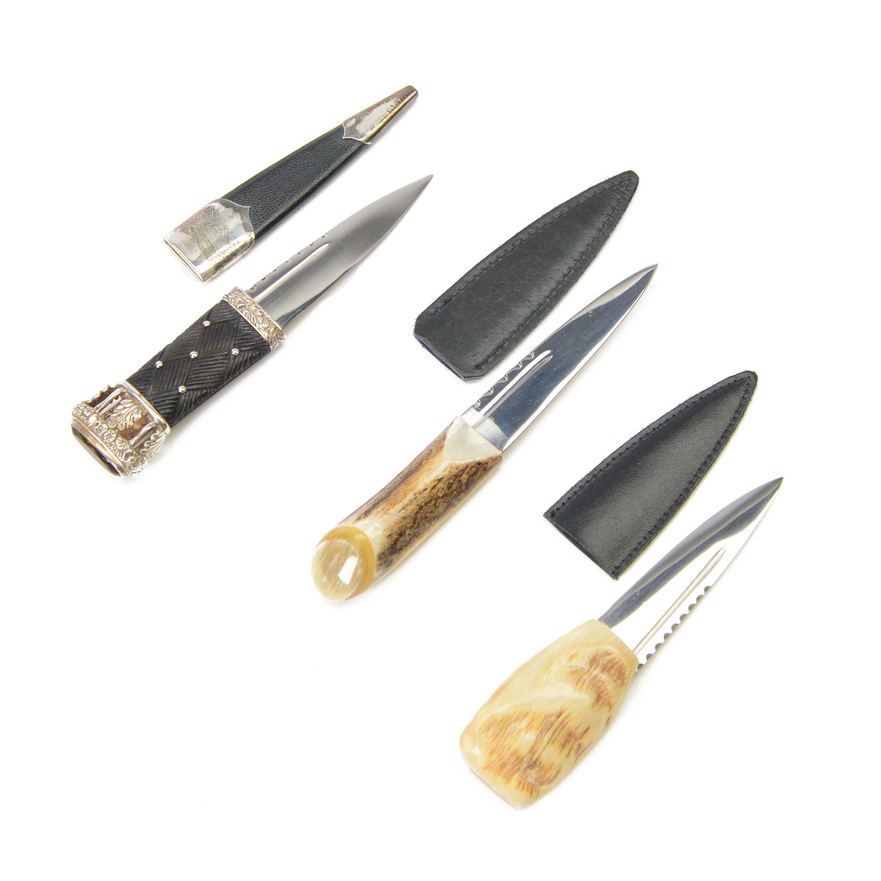 Skean dhu, the 9cm blade with scalloped back edge, with ebonised hilt and stone pommel, in its leather covered sheath with silver collar, hallmarked 1987, together with two other skean dhu  