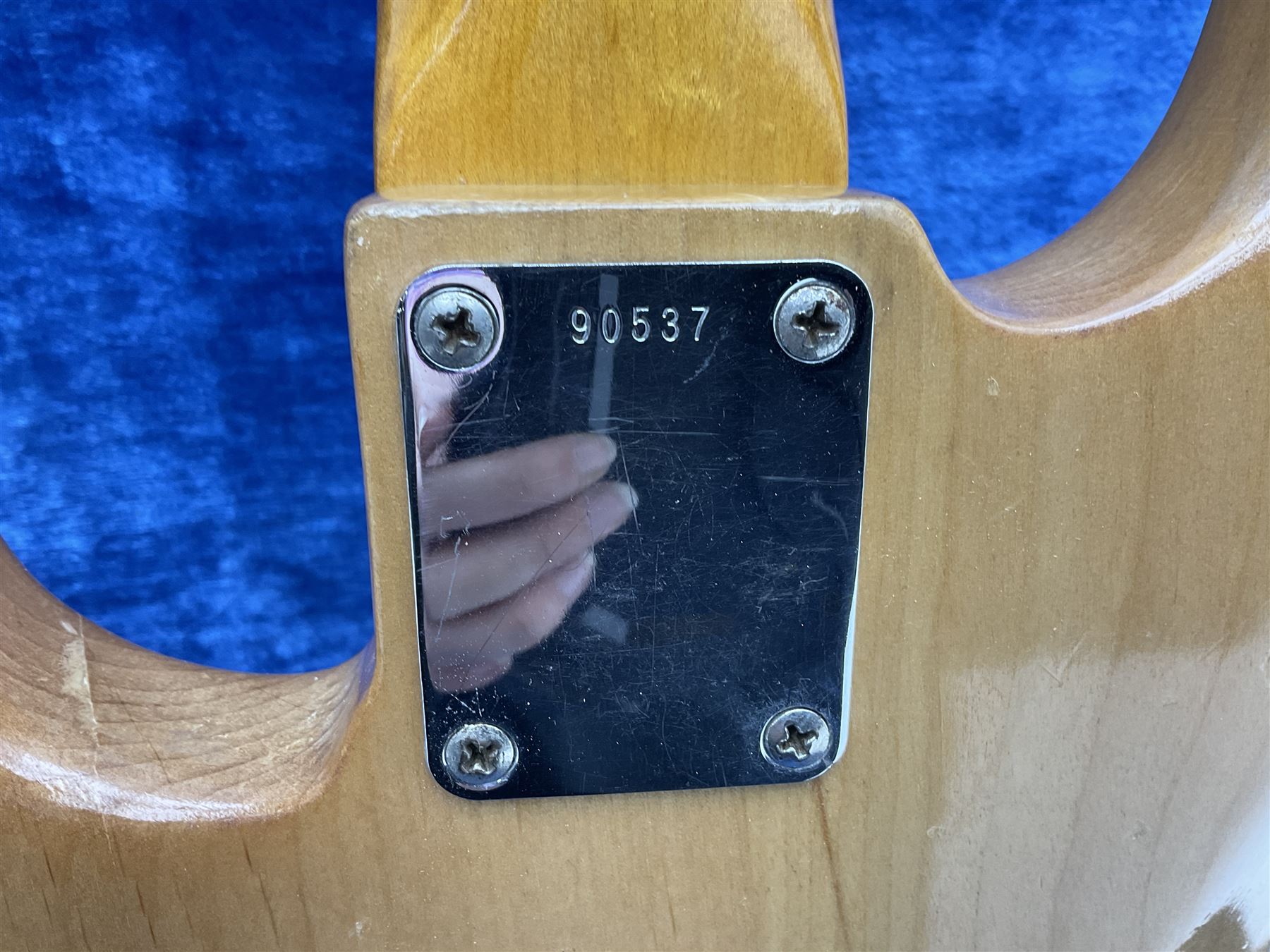 1962 Fender Precision bass guitar; re-finished in natural alder in the 1970s; impressed date code 5NOV62C to end of neck and serial no.90537 to back plate; L115.5cm; in replacement hard carrying case