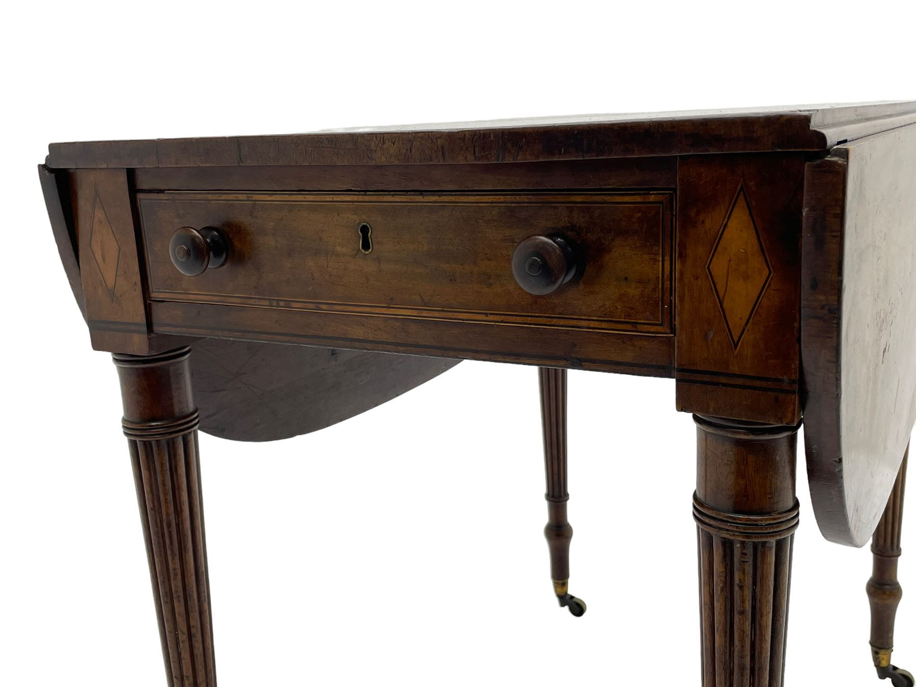 George III mahogany Pembroke table, drop-leaf oval top with satinwood band, fitted with single end drawer, inlaid with satinwood lozenge motifs, on turned and reeded supports with brass cups and castors