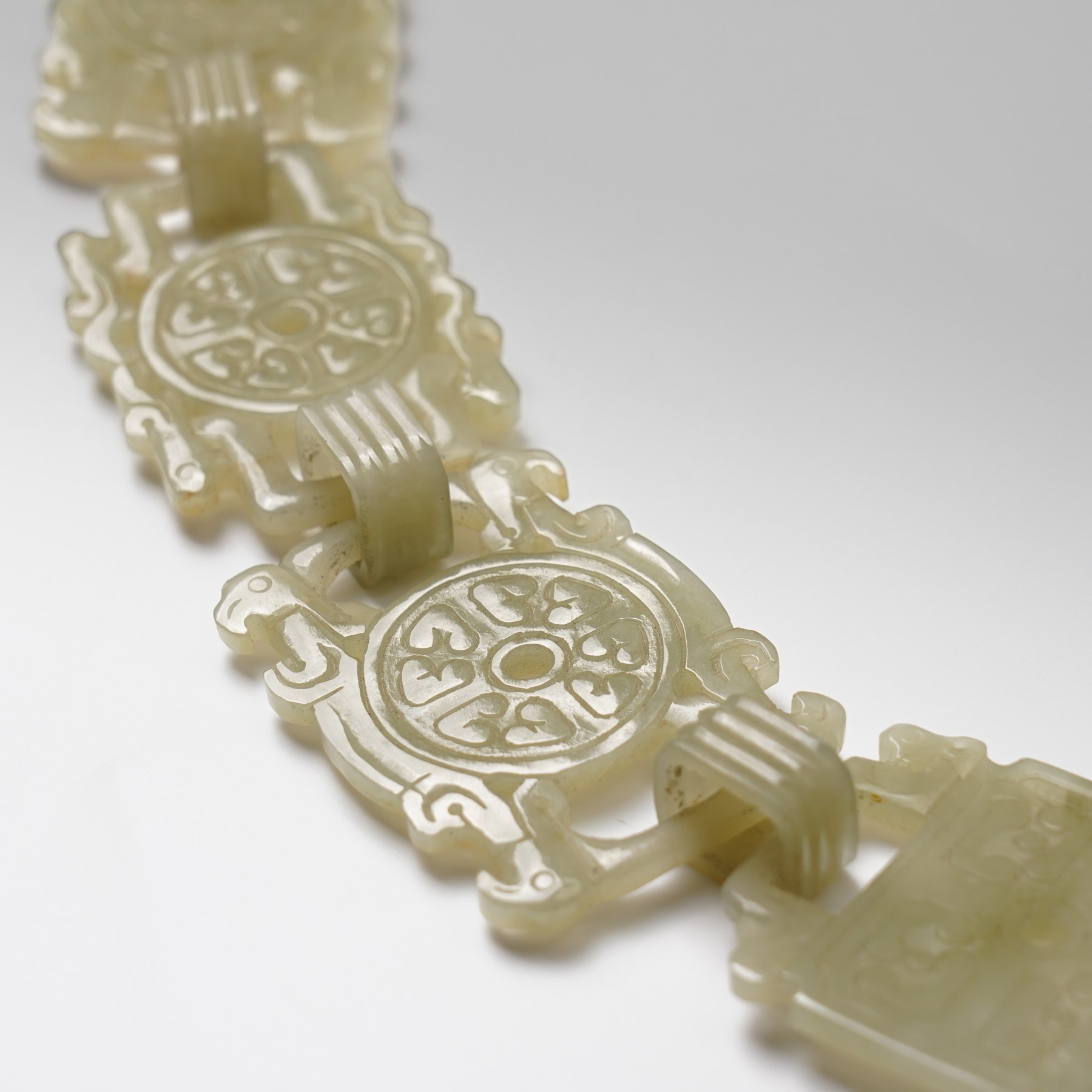 Chinese carved greenstone belt, each link carved with symbols, W108cm 