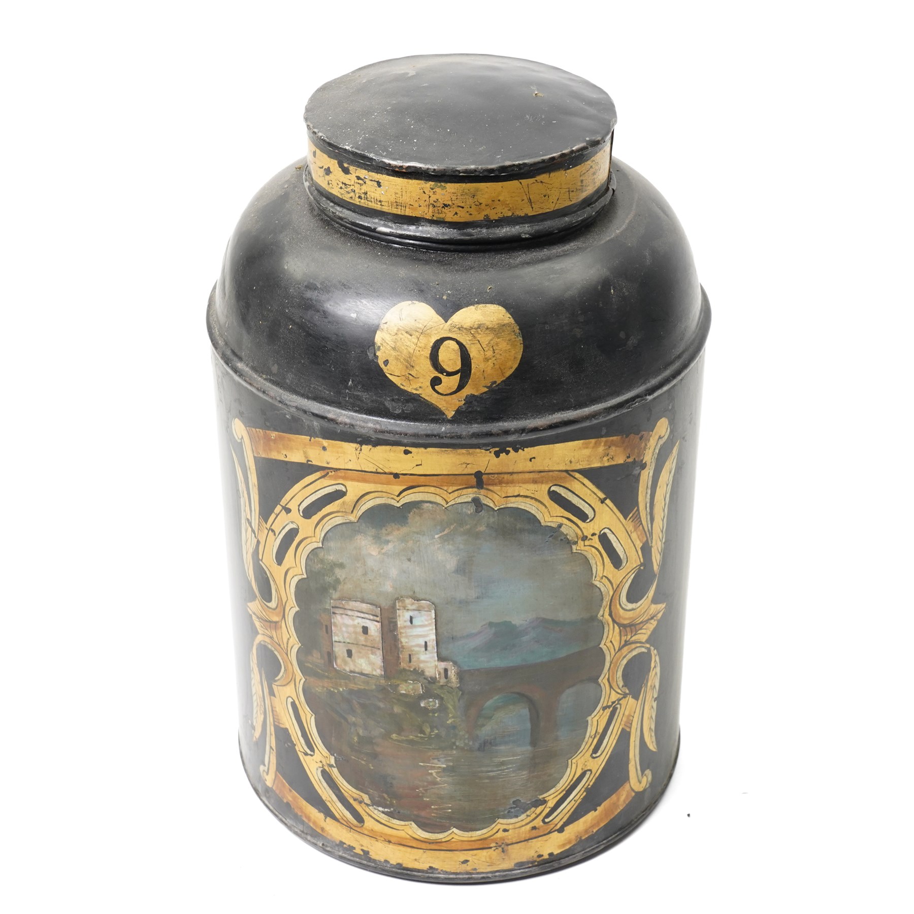 Regency period black toleware canister, painted with a scene of a castle with mother of pearl inlay, within painted gilt border, H39cm 