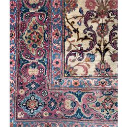 Northwestern Persian Meshkin hand-knotted carpet, the ivory field with an all-over design of scrolling vines and stylised floral sprays in burgundy, pink, and blue tones, enclosed by a raspberry red border of rosettes and palmettes linked by fine arabesques, from the region of Meshkin near Ardabil
