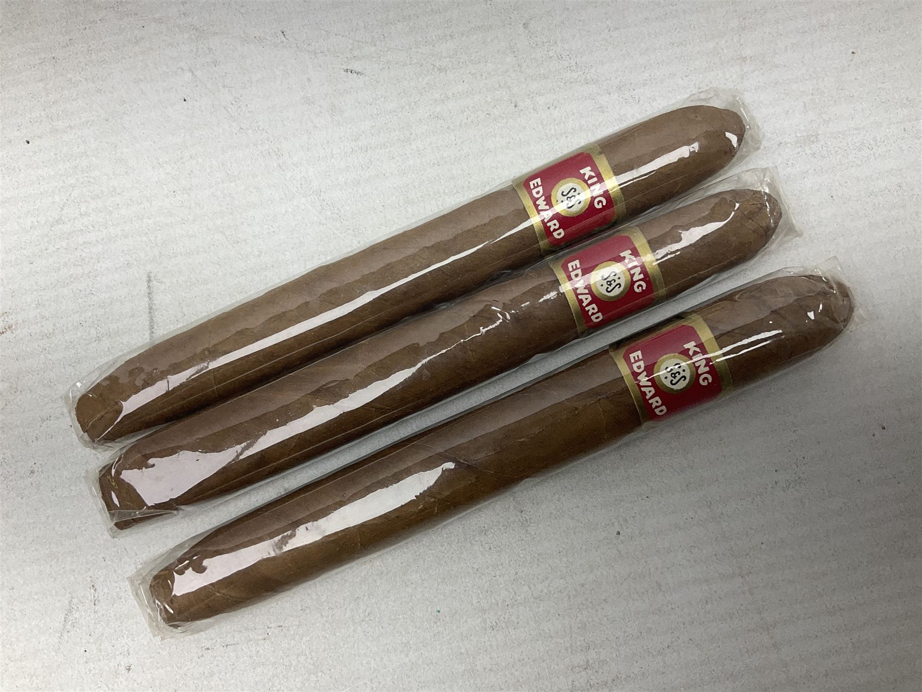 Two sealed packets of King Edward Invincible Deluxe Cigars and another three cigars 