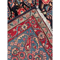 Persian blue ground rug, the navy field decorated with repeating Boteh motifs with interconnecting flower heads, guarded teal border with stylised floral patterns