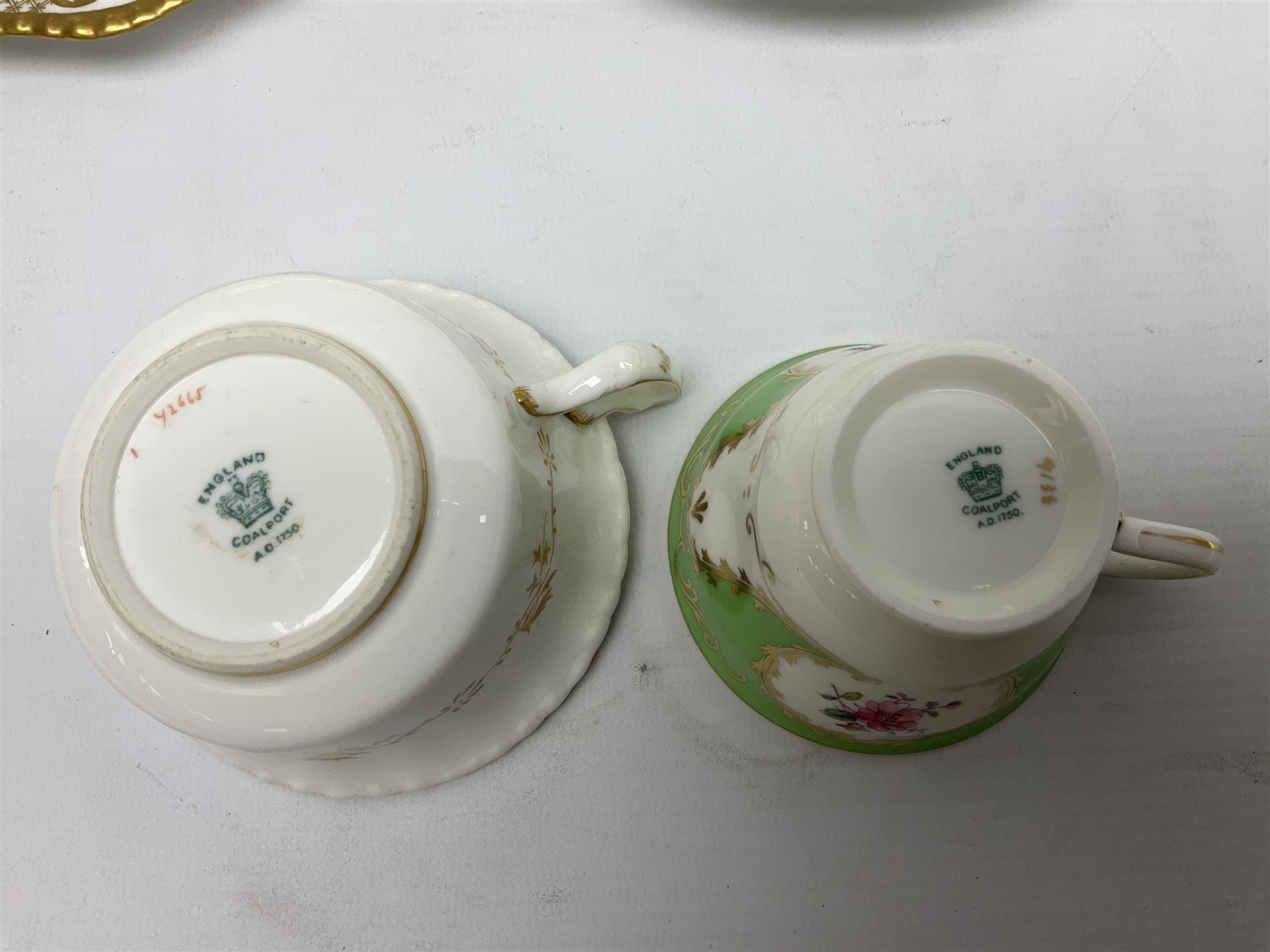 Coalport green batwing pattern tea wares, decorated with finely enamelled floral sprays within gilt reserves, comprising teacup trio, twin handled cake plate and side plate, pattern no Y2665, together with a Coalport for Harrods cup and saucer similarly decorated, the saucer with stamped mark beneath 'Manufactured for Harrods Ltd, Brompton Rd London', all with green Coalport AD 1750 marks beneath, largest W31cm (7)