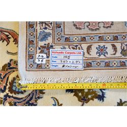 North East Persian Mashad hand-knotted carpet, ivory field decorated with an all-over scrolling floral vine design incorporating stylized palmettes, deer, rosettes and floral sprays enclosed by a conforming floral vine border between multiple guard stripes, cotton fringe ends