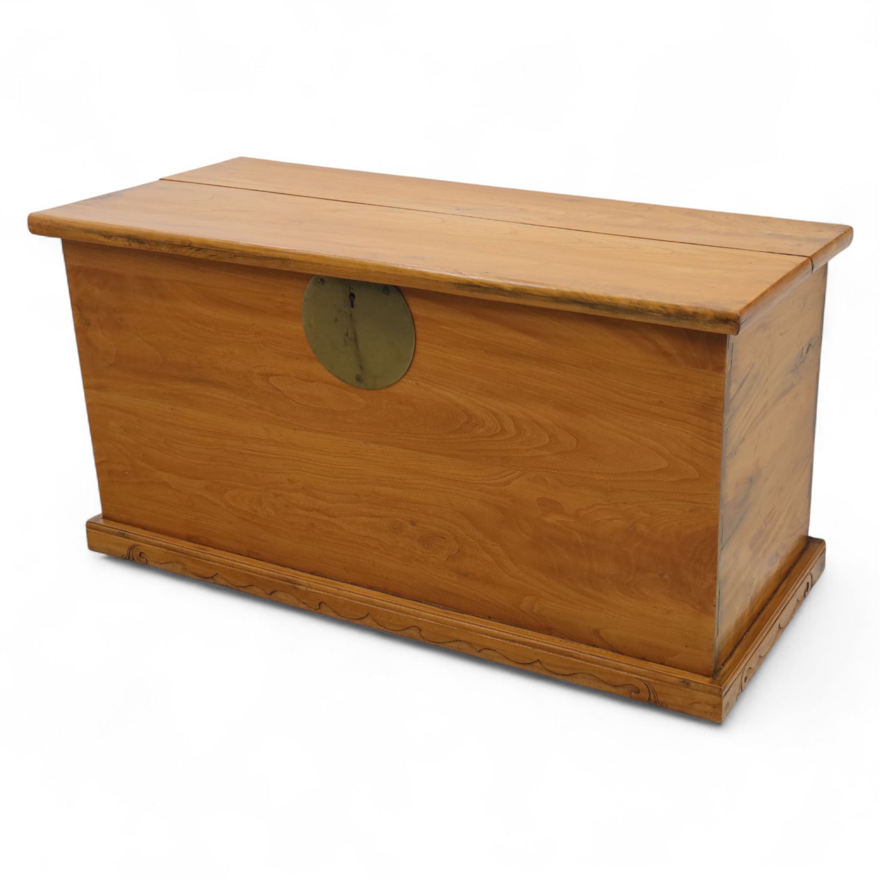 Burmese hardwood and brass inlaid marriage chest, the hinged top enclosing a fitted interior with small drawers, the front decorated with a circular brass medallion, raised on a plinth base