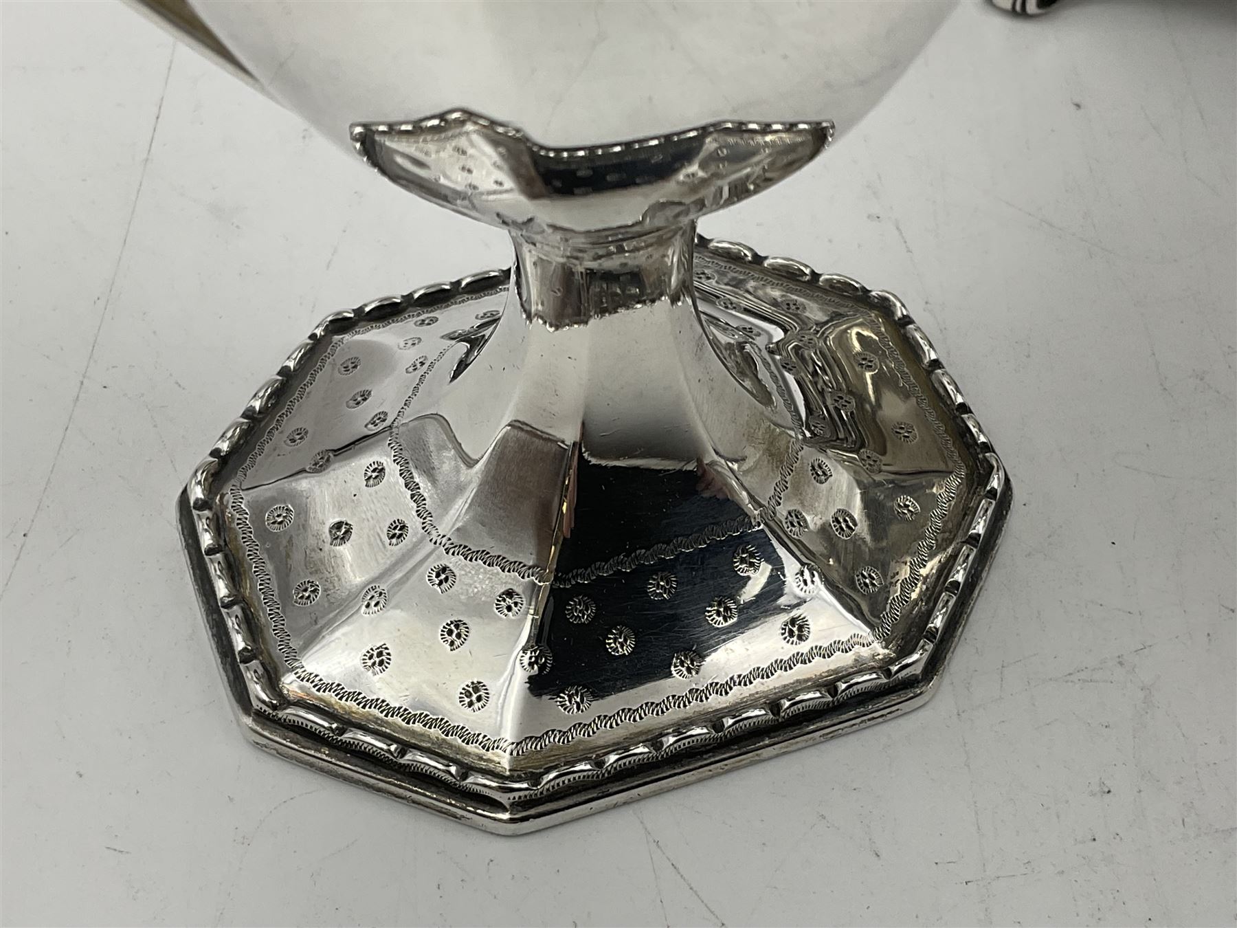 Victorian silver four piece tea service, comprising teapot, teapot stand, twin handled open sucrier and milk jug, each of octagonal form with foliate bud border and engraved decoration including crest to canted panels, and vacant panels, the teapot with ivory finial to the hinged cover and later wooden handle, hallmarked Edward Barnard & Sons Ltd, London1896, teapot including finial H15cm, milk jug including handle H16cm, teapot stand W11.5cm

This item has been registered for sale under Section 10 of the APHA Ivory Act