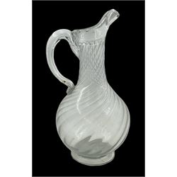 Early 19th century Continental soda glass jug, the wrythen bulbous body with thick rim and lip and hollow curved handle, upon a circular foot, H28.5cm