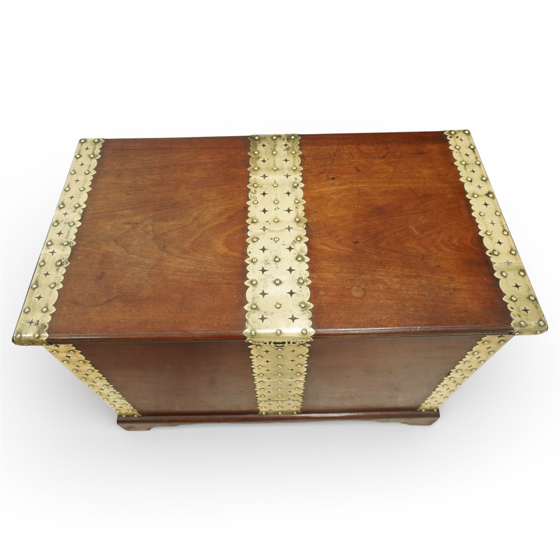 Georgian mahogany brass bound plate chest, the rectangular hinged top mounted with pierced and studded brass straps, fitted with pierced brass escutcheon and large brass handles to the side, lower moulded edge on bracket feet