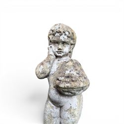 Early composition stone figure of a boy with grape basket, original flakey white paint