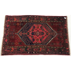 Afghan hand knotted red ground rug, diamond centre with geometric pattern, 195cm x 122cm