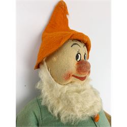 Chad Valley pressed felt figure of the Disney Snow White dwarf 'Doc' with painted facial features, standing wearing a green linen suit with orange hat, belt, buttons and shoes H13