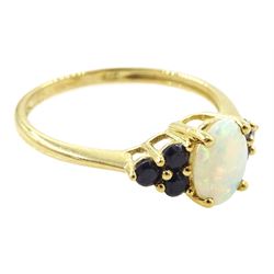 9ct gold opal and sapphire ring, single oval cut opal, with three sapphires set either side, hallmarked