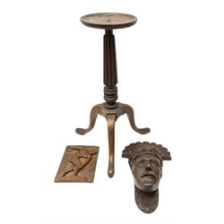 Oak wall bracket, cared in the form of a king with a hinged shelf, together with a wooden plant stand on a carved column and flared legs and a carved wooden plaque 