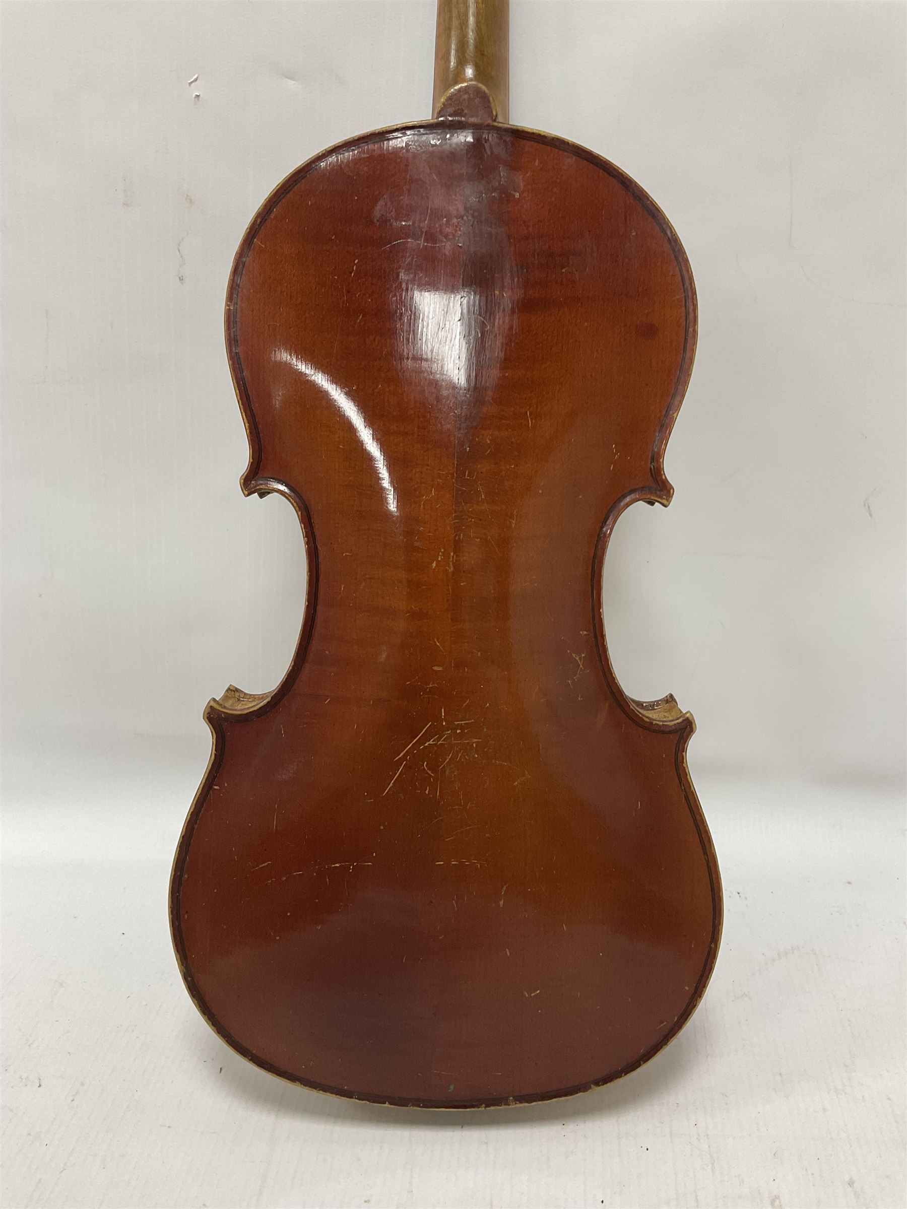 Copy of a full size Stradivarius violin, with an ebonised fingerboard, tailpiece and tuning pegs Length 60cm