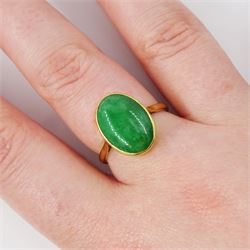 Early - mid 20th century gold jade ring, bezel set with a single oval cabochon jade of approx 4.10 carat, stamped 18ct