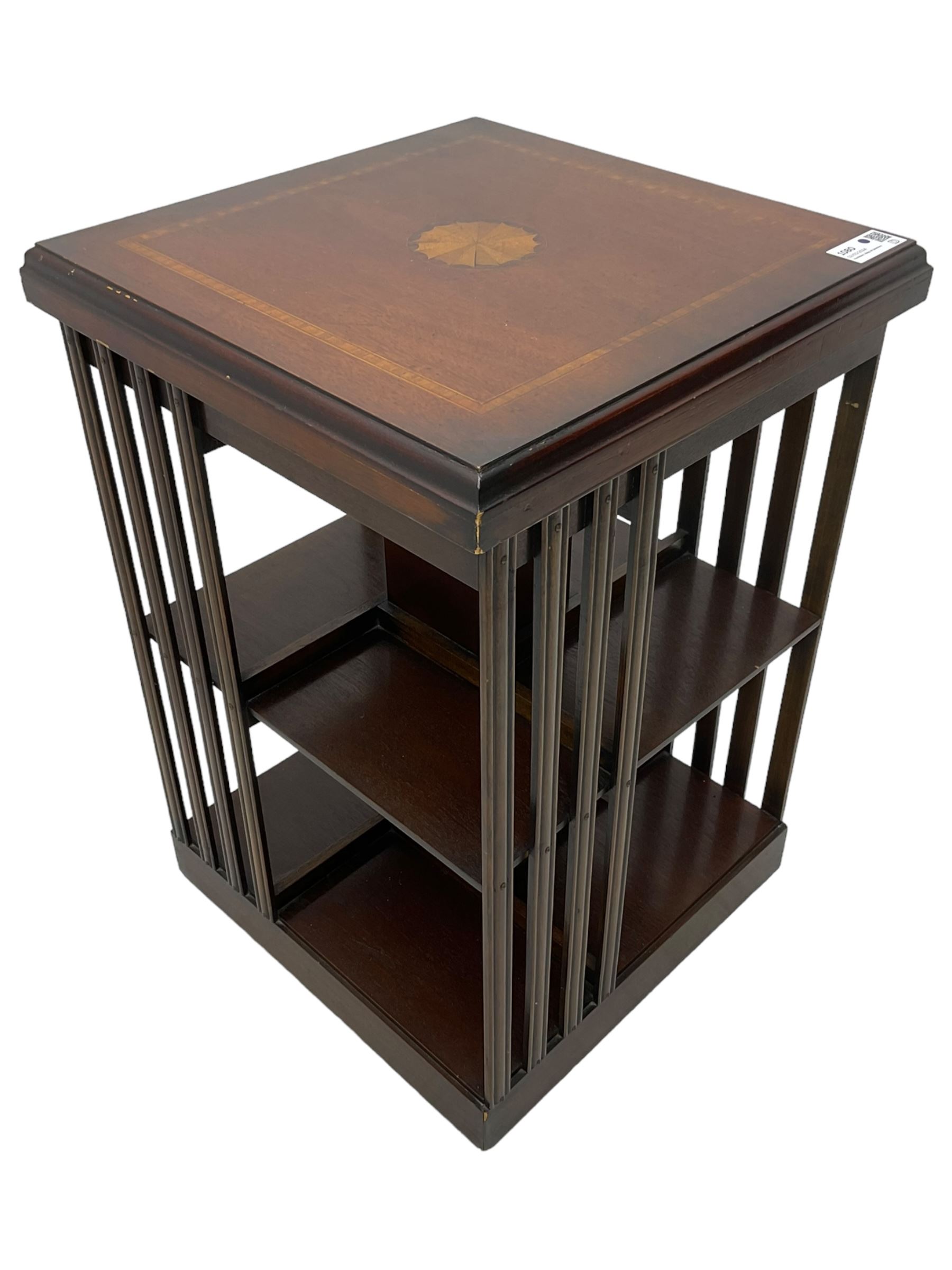 Edwardian revival inlaid mahogany revolving bookcase, square form with moulded top inlaid with central fan motif, two-tiers with moulded upright rails, on castors 