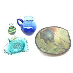A Venetian blue glass bowl modelled in the form of a vine leaf, L18cm, together with a small glass flask with blue banded decoration, H10.5cm, a blue glass jug, H15cm, and a studio pottery bowl detailed to the interior with barbed wire decoration, marked beneath DH, L32.