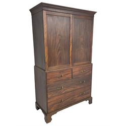 George III mahogany Gentleman's linen press, the projecting cornice over two panelled cupboard doors enclosing three sliding trays, the base fitted with two short over three long graduating cock-beaded drawers, lower moulded edge over bracket feet