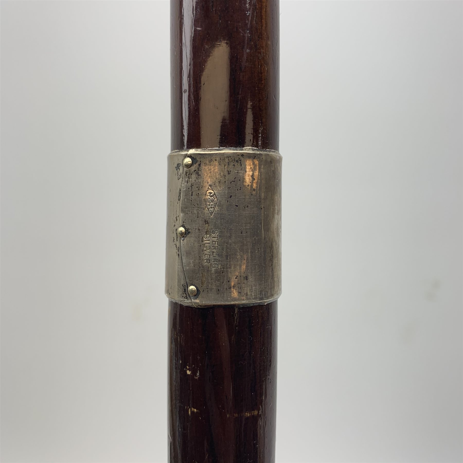 Three silver mounted walking canes, the first hallmarked Kendall & Sons Ltd, London, date letter worn and indistinct, the second hallmarked Birmingham 1924, maker's mark C&S, the third marked Sterling Silver, C&S. 