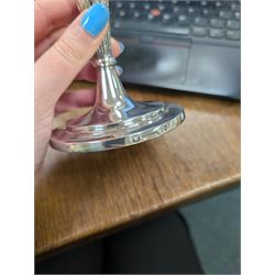 Pair of continental silver candlesticks, probably German Hanau, each of tapering form, with fern leaf decoration, upon a stepped circular base, with Hanau marks and assay scrape to base, H19cm