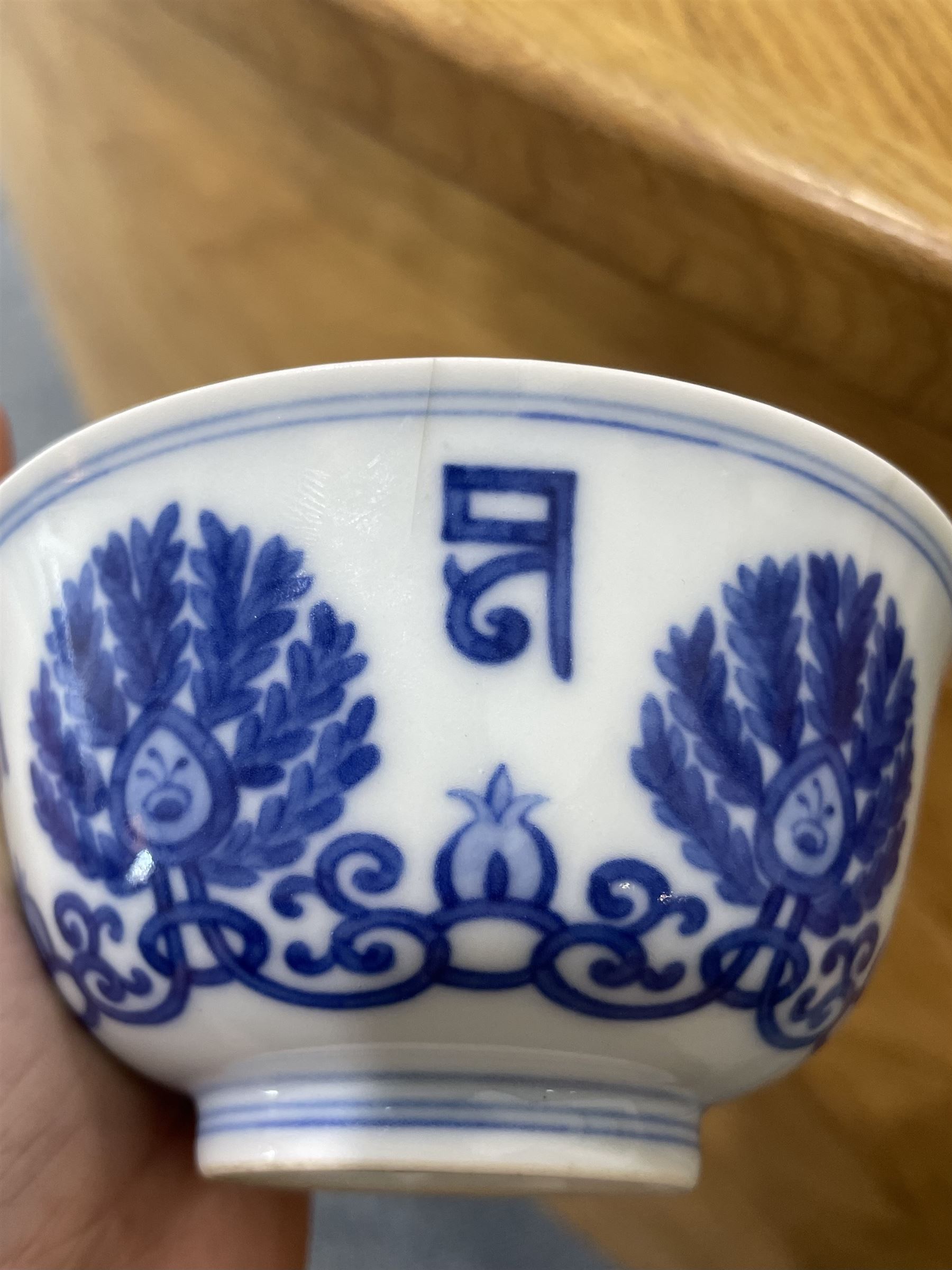 Qing dynasty bowl decorated in blue and white with palmettes and interlocking scrolls with a siddham script border, four character mark D10cm