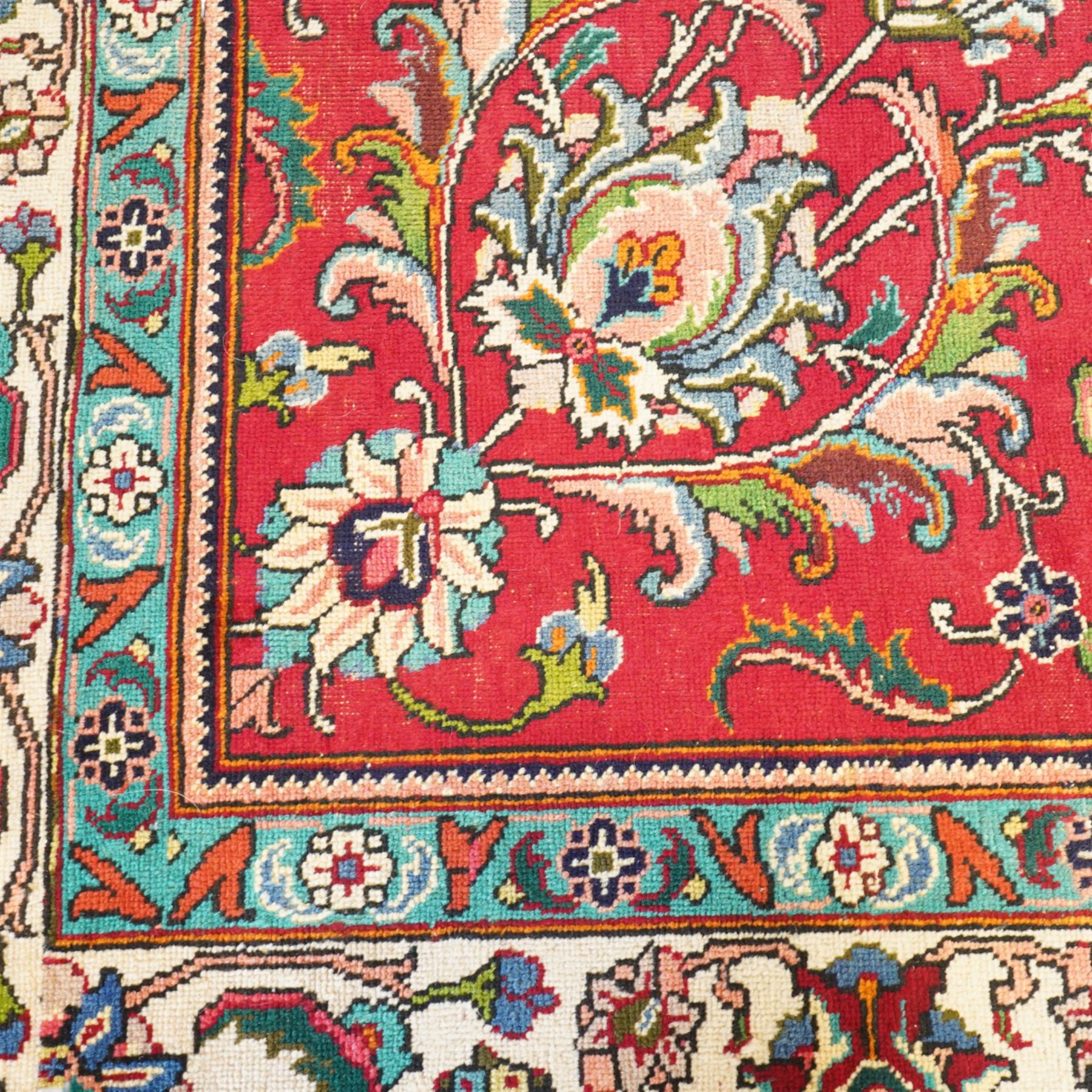 Persian Kashan carpet, red madder field, all over design of scrolling palmettes and flowering vines framed by an ivory border of lotus and arabesques between turquoise and red floral guards 294x387cm