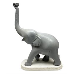 Composite figure of an elephant, painted grey, upon white base, L45cm H65cm