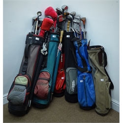  A quantity of golf woods, irons and putters, with six bags, three umbrellas, box of Dunlop 18 golf balls pack, box of Wilson ultra-distance 12 gold balls and other golf balls   