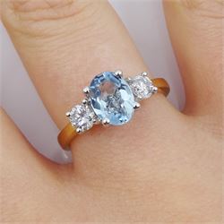 18ct gold three stone aquamarine and diamond ring, hallmarked, total diamond weight 0.40 carat, aquamarine approx 1.25 carat