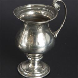 Group of early 20th century silver, comprising sauce boat, with flying scroll handle and upon three pad feet, two small cream jugs and a christening mug, all hallmarked, tallest H10cm