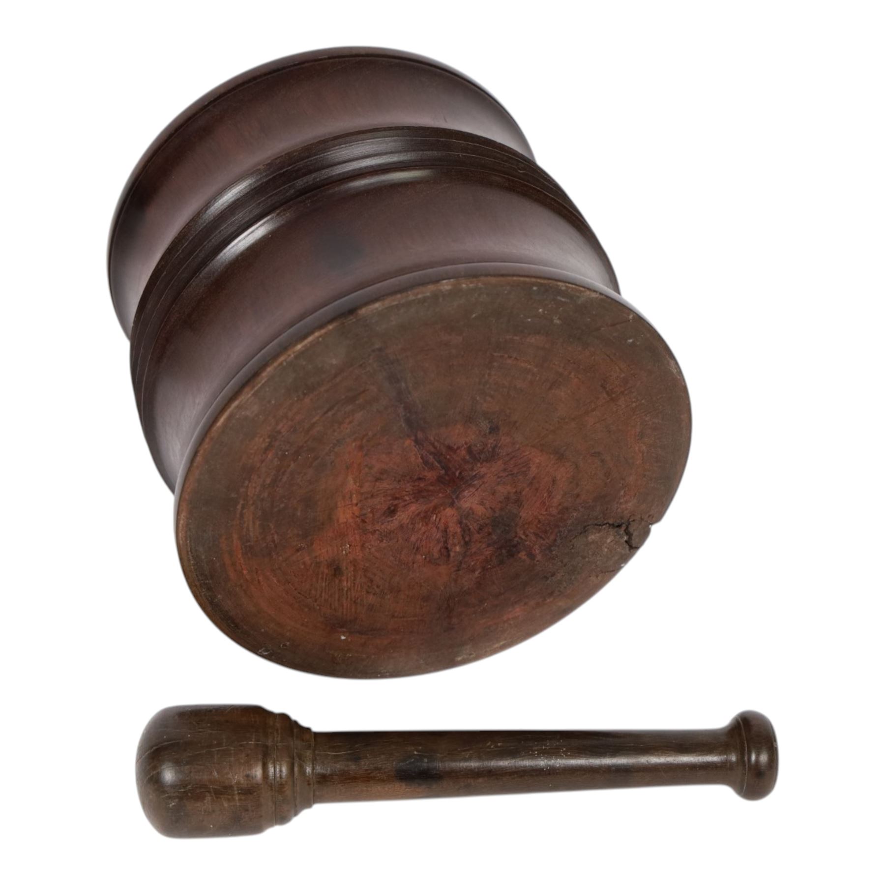18th century lignum vitae captive mortar and pestle, the mortar of turned waisted form with central reeded girdle, and captive opening with rolled rim, H12.5cm D14cm, and pestle L17.5cm
