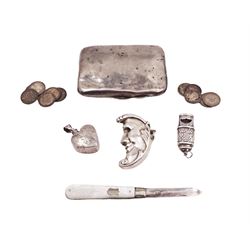 Group of novelty silver items, comprising man in the moon vesta case, perfume pendant and a whistle, unmarked but test silver, together with a mother of pearl handled silver fruit knife, silver cigarette case, both hallmarked and a small quantity of silver threepences