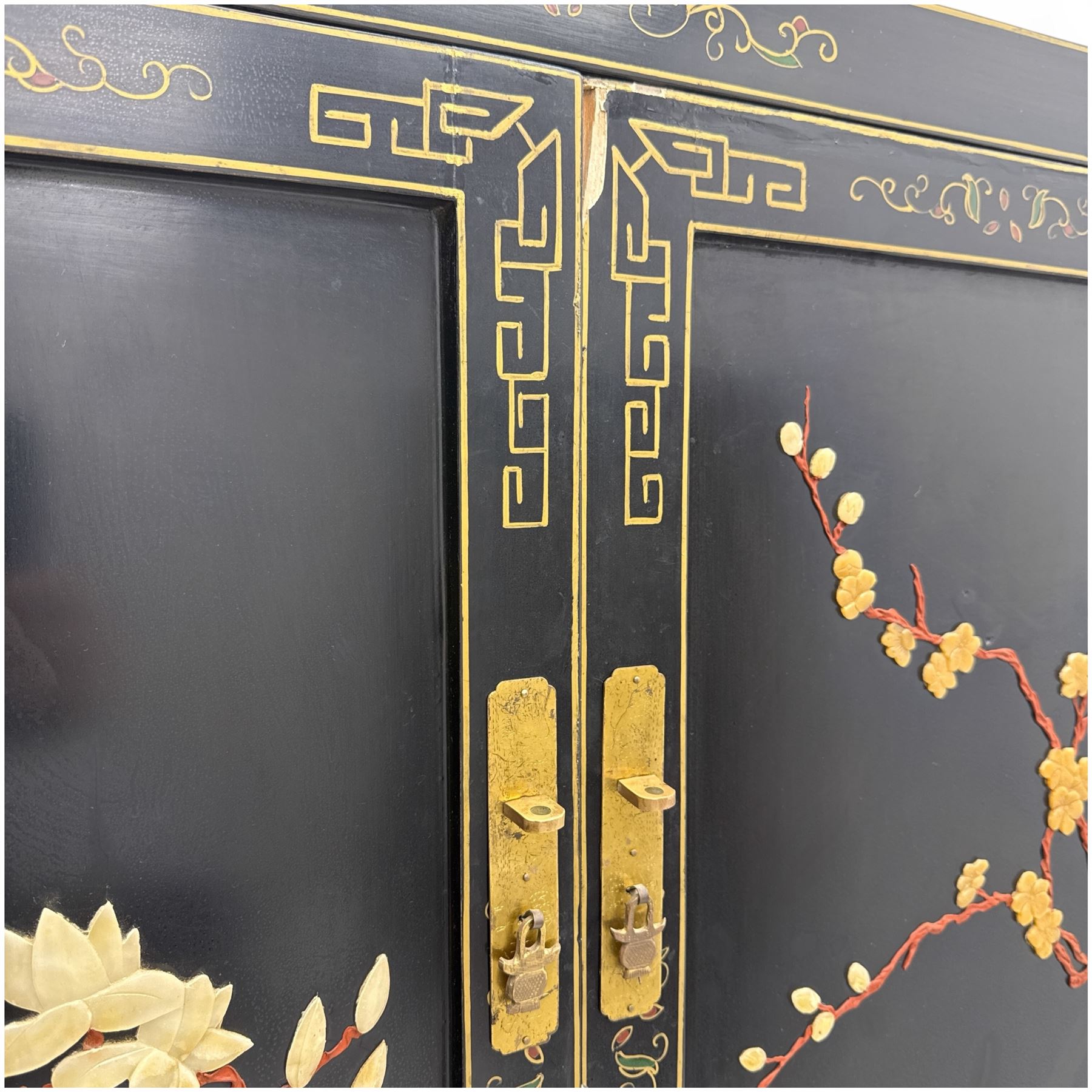 Late 20th century Chinoiserie black lacquer cabinet, the rectangular body decorated with hand-painted floral and foliate motifs in polychrome and gilt, fitted with four panel doors enclosing shelved interior, on shaped apron and stylised cabriole supports with gilt scrollwork