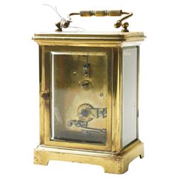 Two early 20th century 8-day French Carriage clocks- one with its original traveling case, lever platform escapement, enamel dial and Roman numerals, the other with a cylinder platform escapement, enamel dial with Roman numerals and five minute Arabic's.  