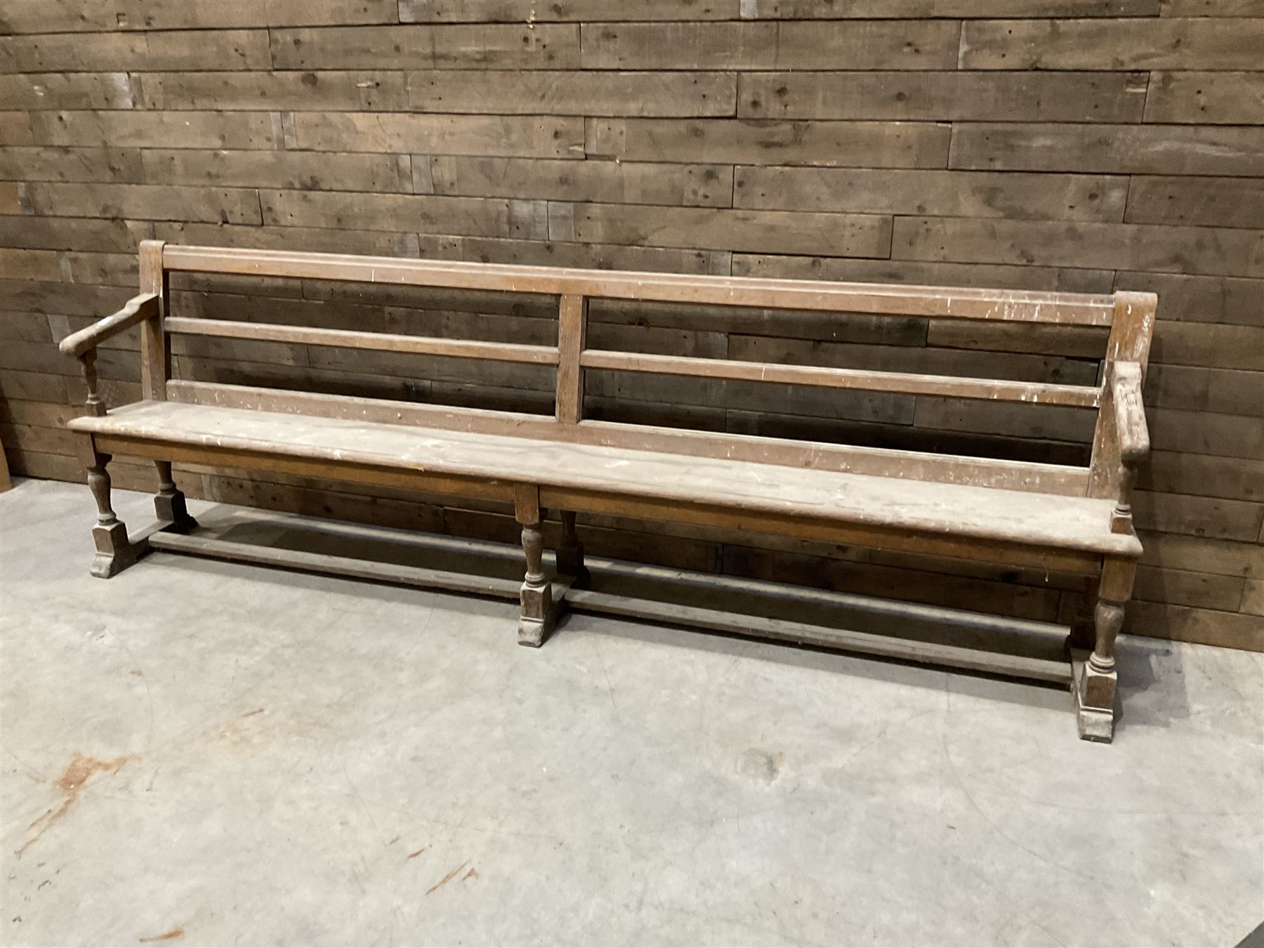 Victorian pitch pine bench pew, turned arms and legs, rail back with plank seat, 274cm